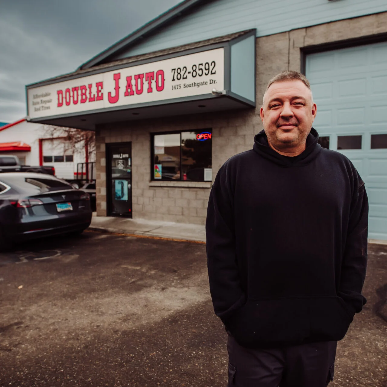 maintenance services, man standing in front of Double J Auto